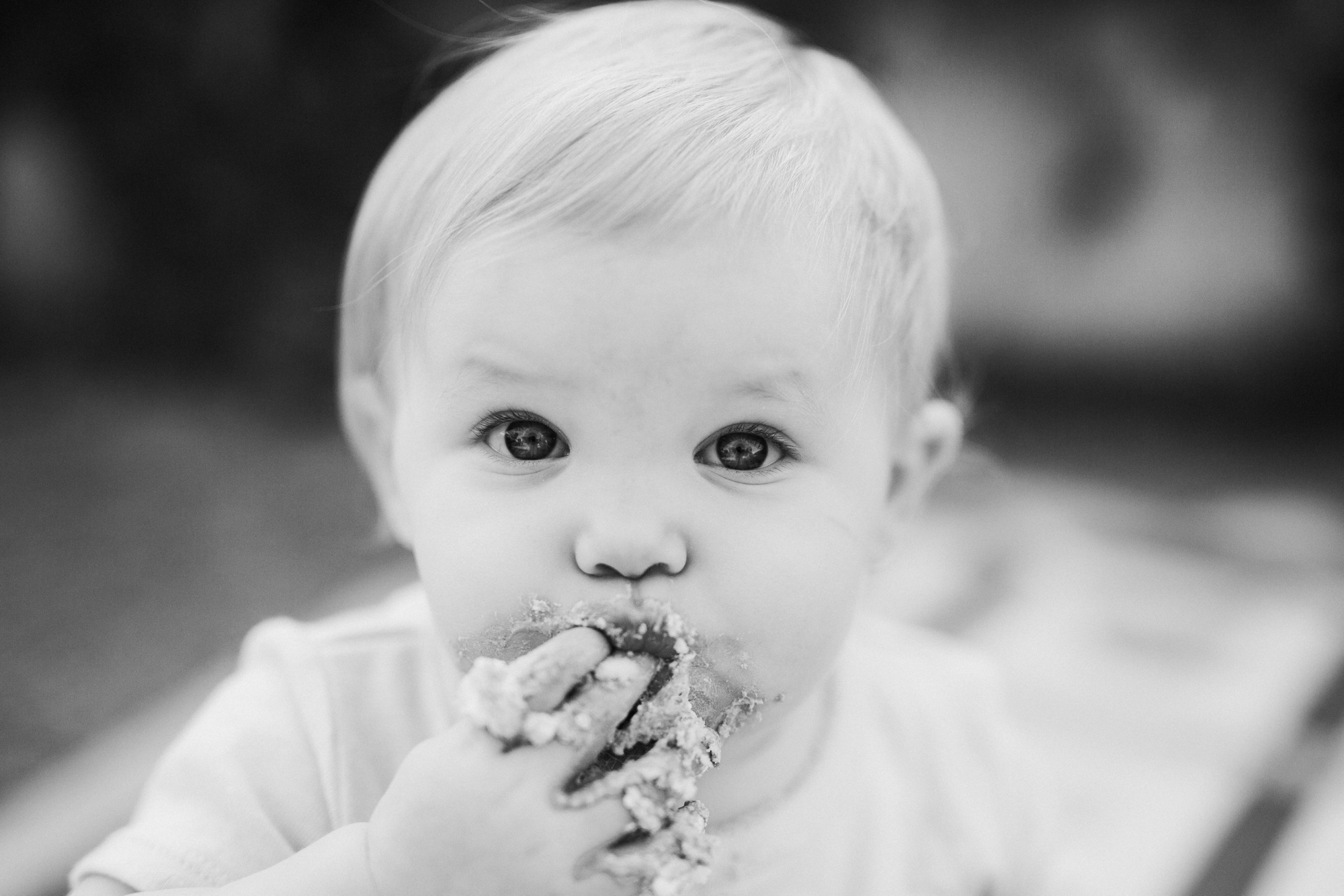 Little girl eating cake.