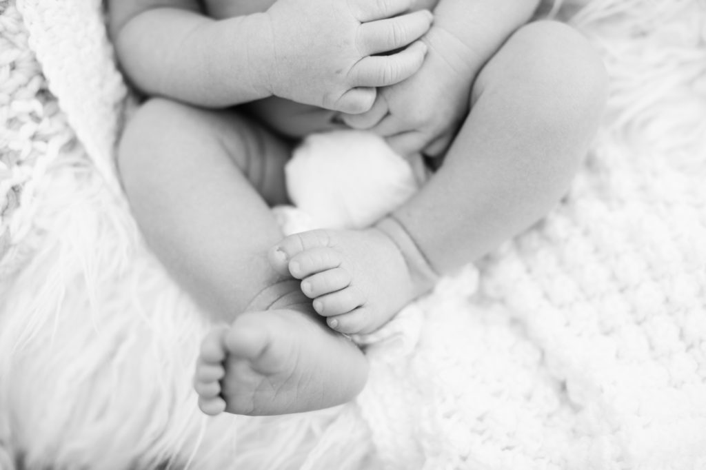 Black and white image of a newborns toes.