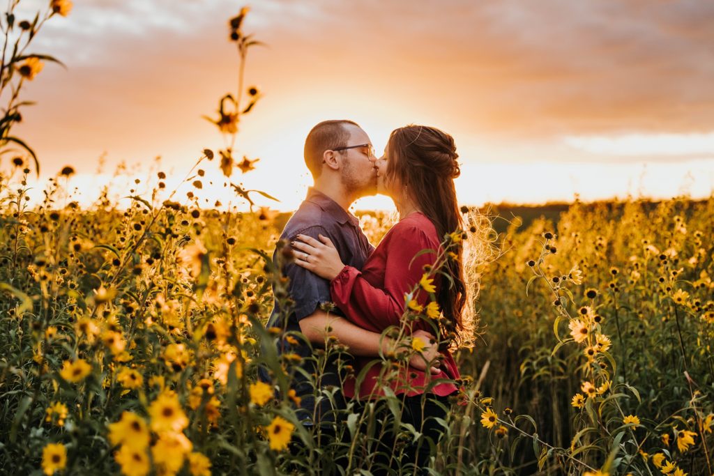 Couple kissing in field of flowers