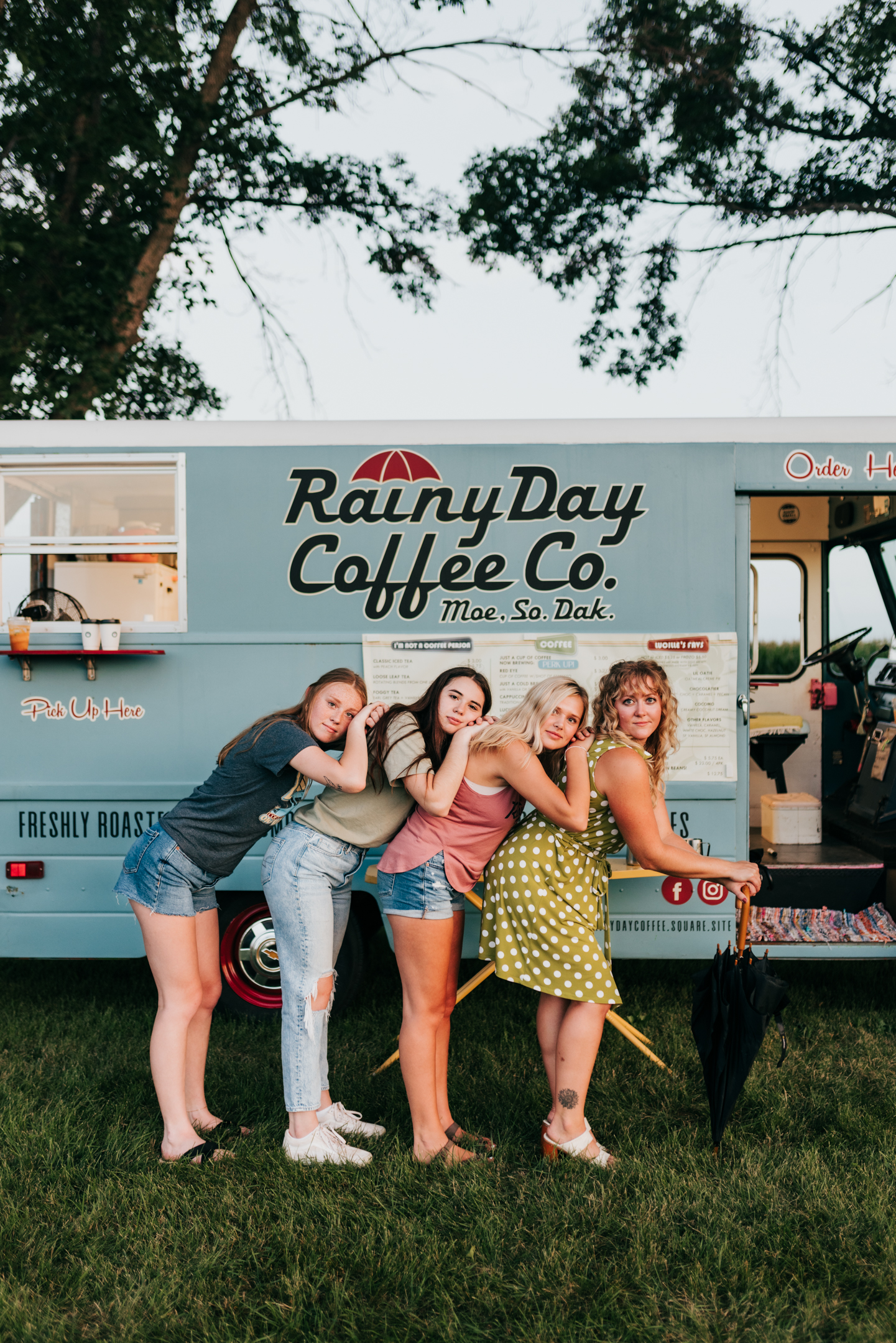 Group of women pose in front of coffee truck.